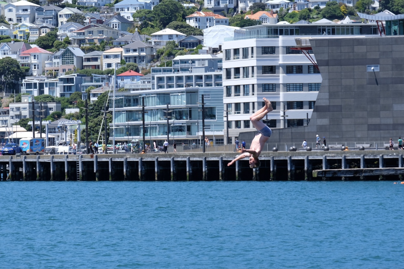 A man does a backflip into Wellington harbour